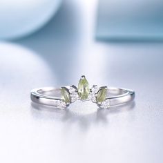 You are looking at a marquise shaped green peridot wedding ring, natural peridot and natural diamond wedding ring. Stone: *2x4mm + 1.5mmx3mm marquise natural green peridot. *Natural Real Diamonds. SI Clarity and H Color. Metal * Solid 10k 14k &18k. *Color:white gold,yellow gold,rose gold. Custom Order *The main stone can be other gemstones you can imagine,any birthstone can be made.Please contact me if you need this service. *Any size *I can also design the matching band. Other *Rush order * Green Stackable Sapphire Ring For Wedding, Green Marquise Diamond Promise Ring, Green Marquise Rings For Wedding, Green Marquise Wedding Rings, Green Stackable Wedding Rings For May Birthstone, Green Topaz Wedding Ring In Sterling Silver, Green Topaz Sterling Silver Wedding Ring, Green Topaz Sterling Silver Ring For Wedding, Green Marquise Cut Promise Ring