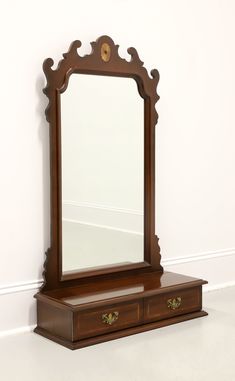 a mirror sitting on top of a wooden dresser