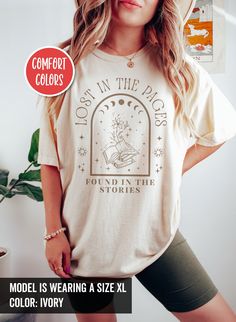 This Mystical bookish shirt proudly declares your love for books and the excitement of embarking on new reading journeys. Wear this shirt and let everyone know that you're a dedicated bookworm. For other similar stuffs, click here: https://www.etsy.com/shop/TheNims?section_id=33576831 Browse through my other awesome items here: http://thenims.etsy.com/ ABOUT THE PRODUCT: UNISEX TEES | Comfort Colors® 1717 (CUSTOMER FAVORITE) * Medium fabric (6.1 oz/yd² (206.8 g/m * Relaxed fit * Sewn-in twill la Poet Shirt Aesthetic, Relaxed Fit Graphic Print Shirt In Bookish Style, Relaxed Fit Graphic Print Shirt With Bookish Style, White Bookish T-shirt As Gift, I Read Banned Books, Banned Books Shirt, Library Shirt, Bookish Crew Neck T-shirt With Graphic Print, Bookish T-shirt With Funny Print And Short Sleeves