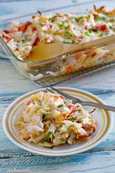 a casserole dish filled with coleslaw and chicken