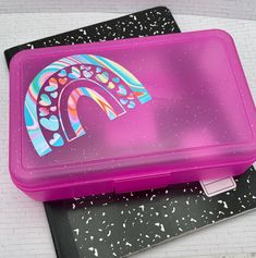 a pink lunch box with the letter n painted on it