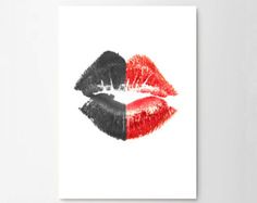 a red and black lipstick kiss on each other in front of a white background with the word