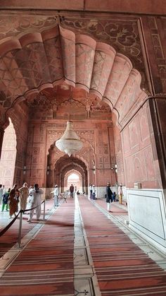 people are walking around in an ornate building