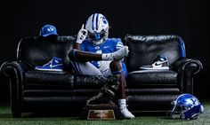 a football player sitting on top of a couch