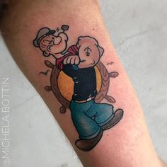 a cartoon character tattoo on the leg