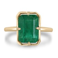 an emerald ring set in yellow gold