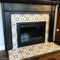 a fireplace with a white and black tile on it