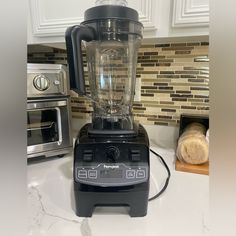 a blender sitting on top of a kitchen counter next to a toaster oven