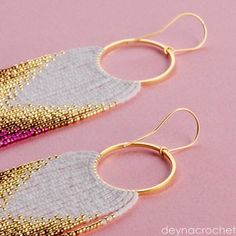 two pairs of gold and silver earrings on pink background