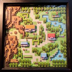 a framed map of a park with houses and trees