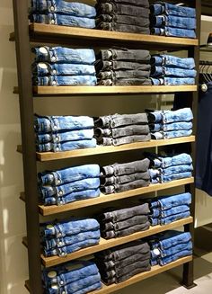 the shelves are full of jeans and shirts