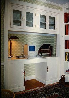 a white desk with a computer on top of it