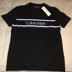 Brand New With Tags Never Worn No Stains No Tears Or Rips No Holes Deadstock Chose Your Size S Or Xl 100% Cotton Color Black What You See In The Pictures Is What You Will Get Fast Shipping 1-3 Days Carefully Packaged Posh Ambassador I Got 5 Star Ratings Well Trusted 100% Authentic I Got 650+ Sales Shop With Confidence Send Reasonable Offers Or They Will Be Rejected Calvin Klein Black T-shirt For Streetwear, Sporty Calvin Klein Tops With Logo Print, Calvin Klein Casual Tops For Streetwear, Casual Calvin Klein Tops For Streetwear, Black Calvin Klein Crew Neck T-shirt, Calvin Klein Black Crew Neck T-shirt, Calvin Klein Casual Short Sleeve Shirt, Casual Calvin Klein Short Sleeve Shirt, Calvin Klein Casual Crew Neck Shirt