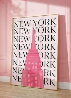 a pink poster with the words new york on it in front of a pink wall