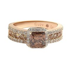 This delicious ring features an asscher-cut brown cubic zirconia center stone, prong-set in a pave white cubic zirconia halo. Crafted of rose gold over sterling silver, this ring continues with a single row of brown princess cut cubic zirconia surrounded by two rows of white cubic zirconia down the band of the ring. So much gorgeous detail gives this ring beauty and shine from every single angle. Surprise someone special in your life with this luxurious anniversary band. The Suzy Levian brand gu Luxury Brown Diamond Ring For Anniversary, Rose Gold Asscher Cut Cubic Zirconia Diamond Ring, Rose Gold Cubic Zirconia Asscher Cut Diamond Ring, Rose Gold Cubic Zirconia Asscher Cut Rings, Gemstone Brooch, Cubic Zirconia Engagement Rings, Cubic Zirconia Bracelet, Cubic Zirconia Necklace, Cubic Zirconia Jewelry