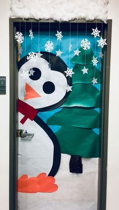 a door decorated with a snowman and christmas tree