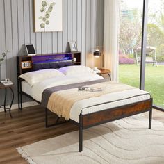 a bed sitting on top of a wooden floor next to a window