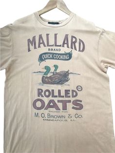 a t - shirt with an image of a mallard duck cooking rolled oats on it