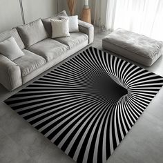 a black and white rug in the middle of a living room next to a couch