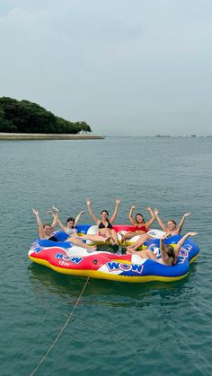 a group of people riding on top of an inflatable boat