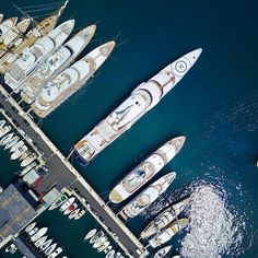 several boats are docked in the water near each other