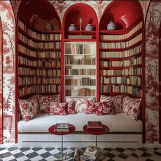 a room with red bookshelves filled with lots of books