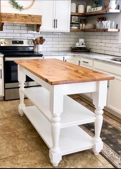 a kitchen with white cabinets and an island