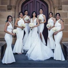 a group of bridesmaids posing for a photo in front of a church door