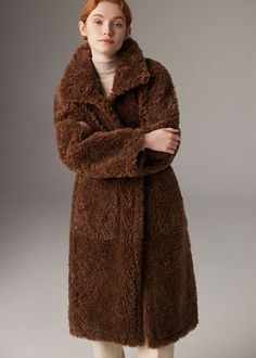 Wrap yourself in luxury with our Larissa Coffee Wool Fur Teddy Coat. Crafted with premium sheepskin and plush wool, this coat will keep you warm and stylish all winter long. The added thickness ensures maximum coziness, making this the perfect choice for the fashion-conscious woman. 100% wool sheep fur Oversize fit Collared Single-breasted button closure Two side pockets Drop shoulders Dry clean Item #132282 Women's winter wool coat/jacket SIZE INFO XS=US2=UK6=EU32 S=US4-6=UK8-10=EU34-36 M=US8-1 Luxury Long Sleeve Fluffy Outerwear, Brown Shearling Fur Coat, Brown Shearling Fur Coat With Long Sleeves, Cozy Brown Long Sleeve Fur Coat, Brown Faux Fur Long Coat, Luxury Fluffy Long Sleeve Outerwear, Brown Long Fur Coat For Work, Luxury Fluffy Outerwear For Fall, Fall Sheepskin Outerwear In Mink Color