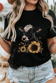 ** All shirts listed are unisex, meaning loose but true to size. If you want a more form fitting shirt I recommend sizing down. Parts of the design were created using AI tools. This classic baby cow farmer t-shirt fits like a well-loved favorite. Soft cotton and quality print make users fall in love with it over and over again. These t-shirts have-ribbed knit collars to bolster shaping. The shoulders are tapered for a better fit over time. Dual side seams hold the garment's shape for longer.  .: Made with 100% Airlume combed and ring-spun cotton, a lightweight fabric (4.2 oz/yd² (142 g/m that is easy to layer, breathable. Perfect for active and leisure wear.  .: The retail fit that is perfect for casual and semi-formal settings. The crew neckline adds a classic, neat style that's perfect f Spring Black T-shirt With Custom Print, Cute Black Printed Tops, Black Custom Print T-shirt For Spring, Black T-shirt With Sunflower Print For Spring, Cute Black Top With Sublimation Print, Graphic Tee With Sunflower Print And Crew Neck, Graphic Tee With Sunflower Print And Short Sleeves, Relaxed Fit Sunflower Print Graphic Tee, Sunflower Print Graphic Tee