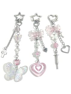 three key chains with charms attached to them, one has a butterfly and the other has a heart