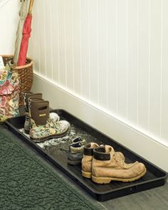 there is a tray with shoes on the floor