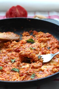 a skillet filled with food and a spoon