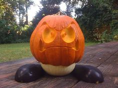 a carved pumpkin sitting on top of a wooden table