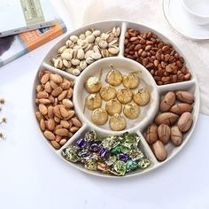 a white plate topped with nuts and chocolates