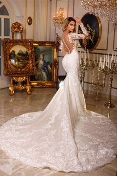 a woman in a wedding dress posing for the camera