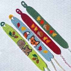 three cross stitch keychains with animals on them