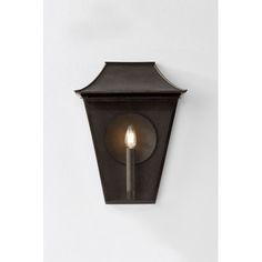 an outdoor wall light with a candle on it