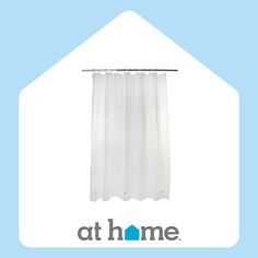 a white shower curtain with the words at home on it's bottom and an image of a blue house behind it