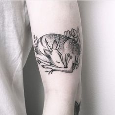 a person with a tattoo on their arm has a mouse in it's hand