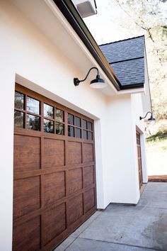 a house with two garage doors and windows