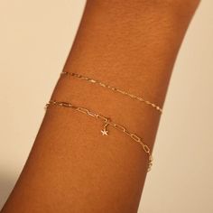 A wrist in front of a soft beige background models two bracelets! The lower of the two hosts a tiny solid gold charm! Dainty Star Charm Jewelry For Party, Dainty Jewelry With Star Charm For Party, Catbird Jewelry, Permanent Jewelry, Tiny Charm, Tiny Dancer, Recycled Gold, Jewelry Inspo, Star Charms