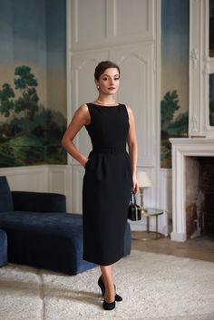 "The Victoria black pencil dress is inspired by Audrey Hepburn's iconic style, embodying timeless elegance and refinement. Featuring a sleek, form-fitting silhouette that gracefully accentuates the waist and hips, this dress includes a modest neckline and subtle, refined details. Its clean lines and high-quality fabric ensure a chic, polished look, perfect for channeling Hepburn’s classic grace. And for a delightful surprise, it has a built in belt and hidden pockets.” – Anastasiia The model mea Audrey Hepburn Black Dress, Modest Black Dress, Audrey Hepburn Outfit, Audrey Hepburn Dress, Modest Neckline, Black Pencil Dress, Audrey Hepburn Style, Victoria Dress, Iconic Style