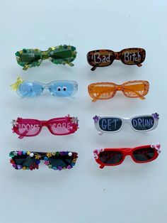 six pairs of sunglasses with the names of each pair on them, all in different colors