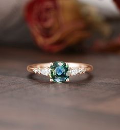 "Engagement ring - center stone:Blue Green Sapphire 5mm round cut - width: approximately 1.5mm  - thickness: approximately 1.3mm Side stone:Moissanite or Diamond - diamond:0.16ct,2*3mm pear cut,Color G-H,Clarity SI-VS - moissanite:0.16ct * Click on the \"Pin It\" icon if you like this item * Custom Order We can make custom rings in almost any shape and style. If you want a specific model, please send us a clear picture and we will do our best.  * Shipping Most items take 3-4 weeks to create.I'm happy to rush your order, fees may apply, write me for details. * Payment Plans I offer payment plans. The minimum per payment will be $100. Write me your finger size, metal color, How much you would like to pay for the first payment. I will create a payment plan which will be customized specially f Heirloom Style Round Emerald Promise Ring, Emerald Crystal Ring With Center Stone, Heirloom Style Round Crystal Promise Ring, Vintage Round Diamond Ring With Accent Stones, Heirloom Green Sapphire Ring, Round Sapphire Promise Ring For May Birthstone, Vintage Round Sapphire Ring With Accent Stones, Sapphire Ring With Center Stone For May Birthstone, Heirloom Style Round Emerald Cluster Ring