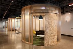 an office with a circular room divider in the middle