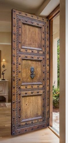 an old wooden door is open to the outside