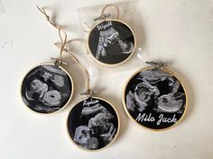 three embroidered ornaments hanging from strings on a white counter top with the words, willie jack written in black