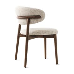 an upholstered chair with wooden legs and a white fabric seat pad on the back