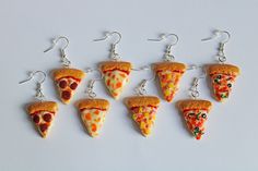 six slices of pizza are hanging from silver earwires